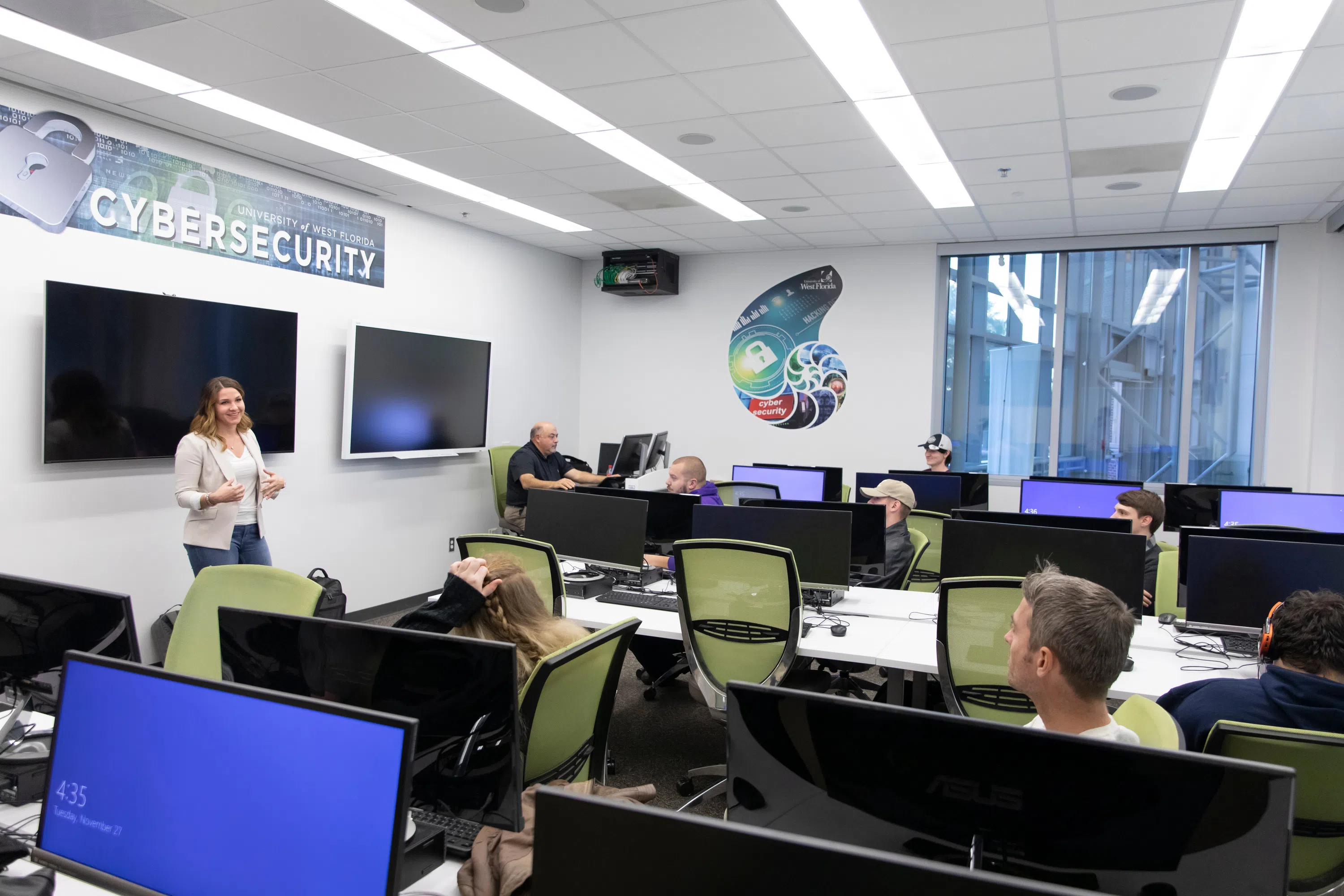 Presenter speaking to club in a computer lab.