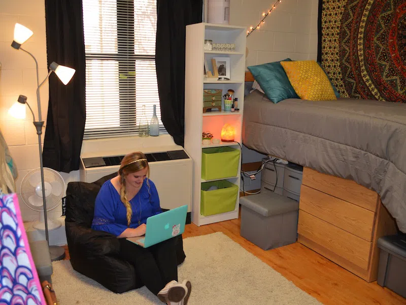 A woman studying on the floor with laptop in Martin Hall