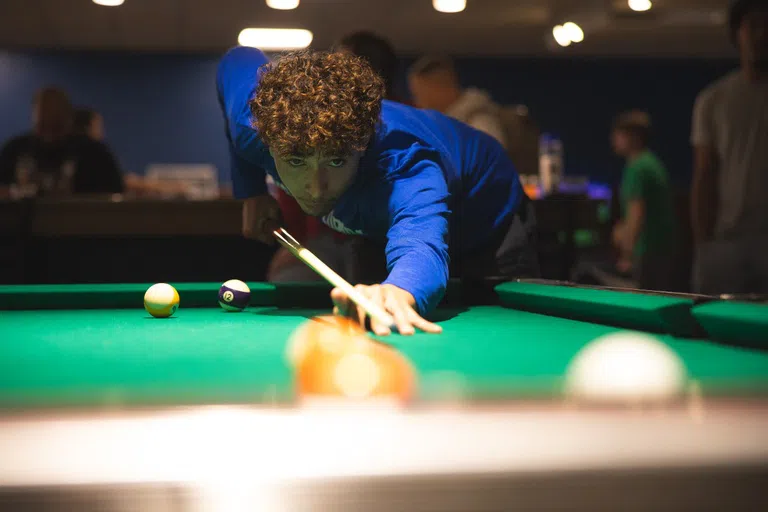 Student playing pool