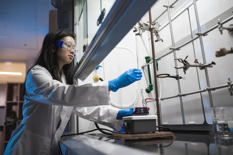 UWF chemistry student conducting lab experiments in the Lab Sciences Annex, Building 58C.