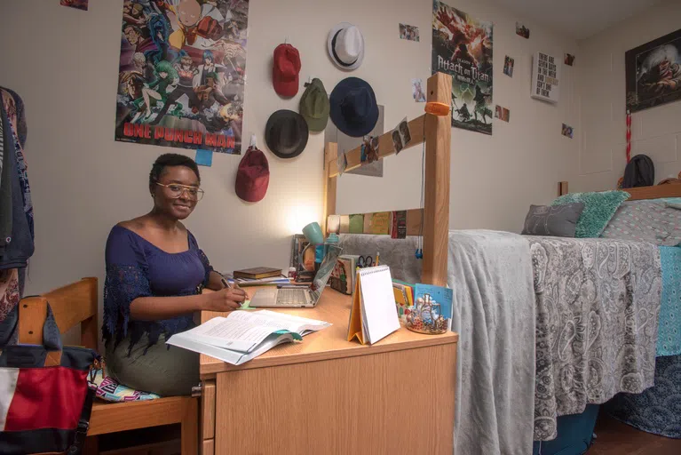 Student studying at their desk in a Pace Hall room.