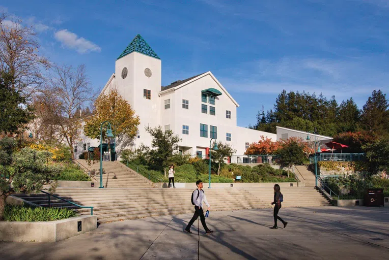 Students walk near a building