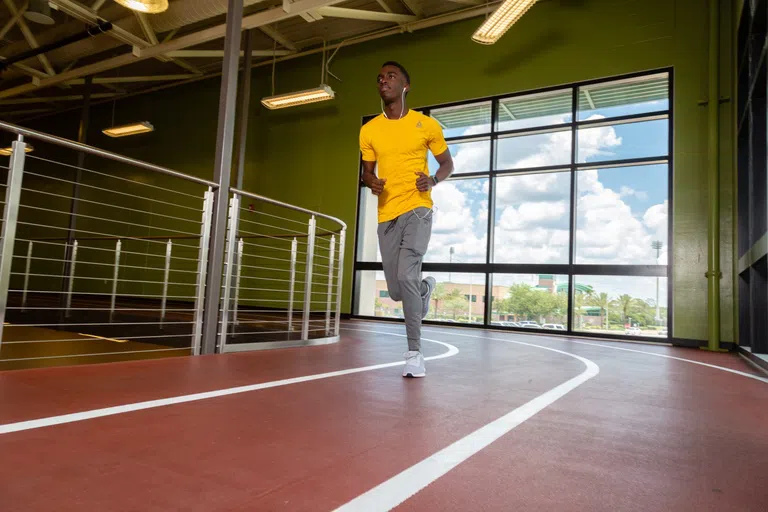 Student running on the indoor track 