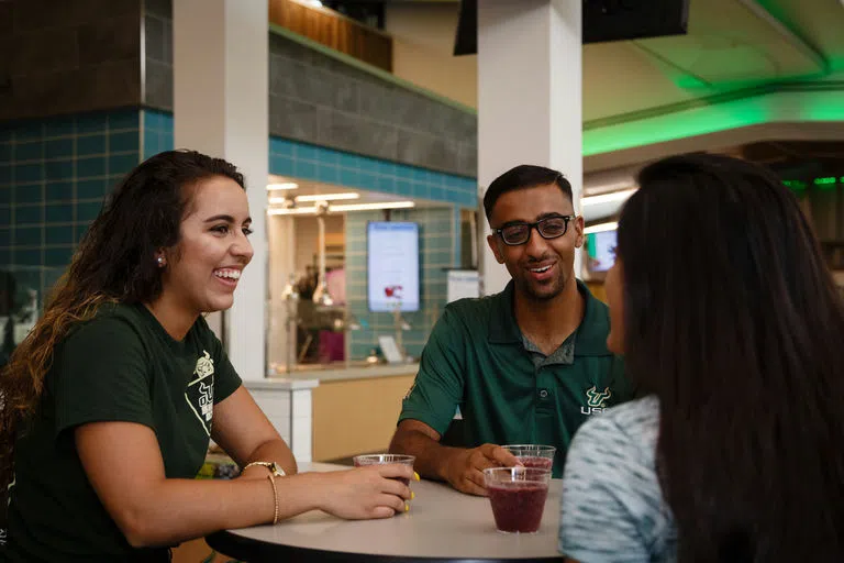 Students chatting at a table at The Hub dining hall.