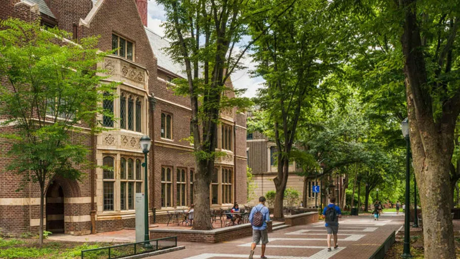 Exterior of the ARCH Building on Locust Walk, where La Casa Latina is located. There are chairs and tables on a patio area in front. 