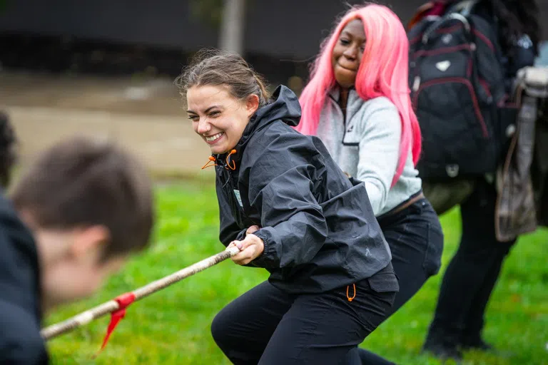 Students participate in tug of war, part of Club Olympics, an event hosted by the Student Association (SA).