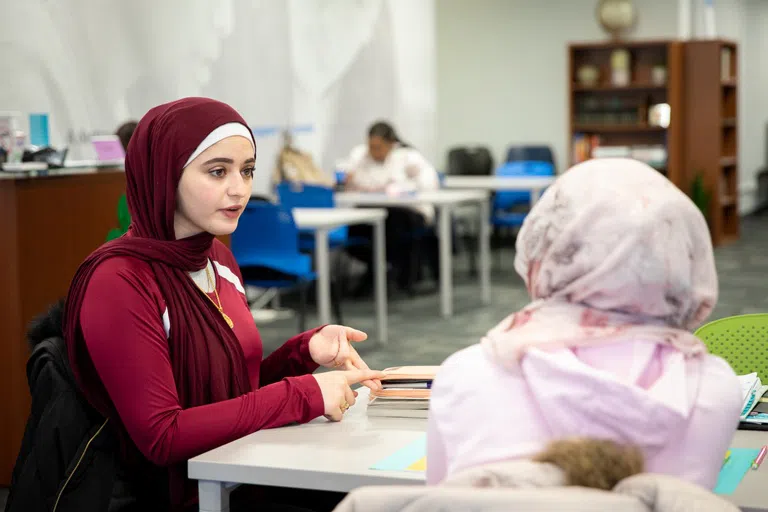 Two students at the Tutoring and Academic Support Services office at UB