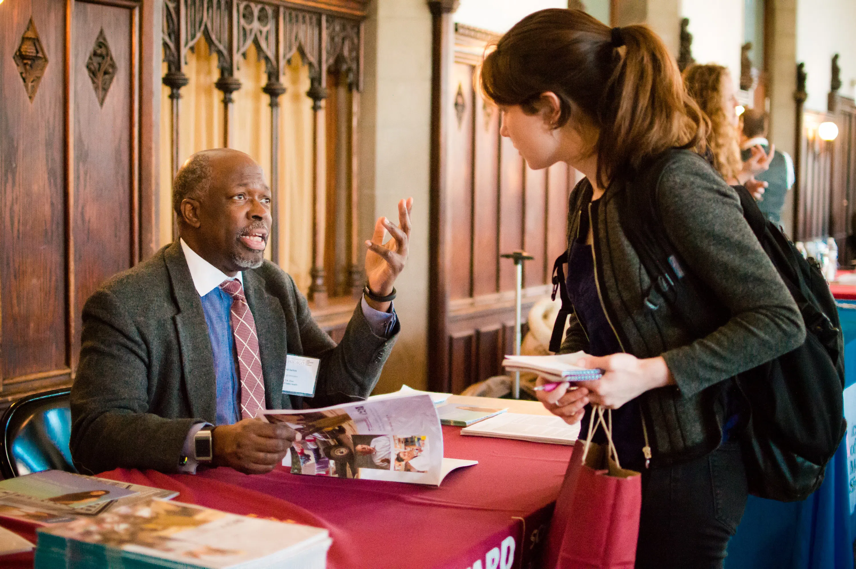 A student talks to a representative at a career fair