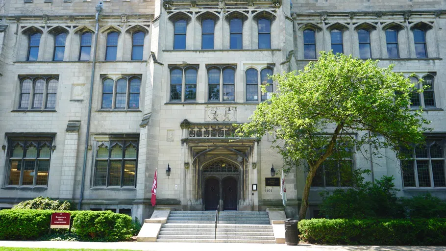 A building with maroon flags at the entrance