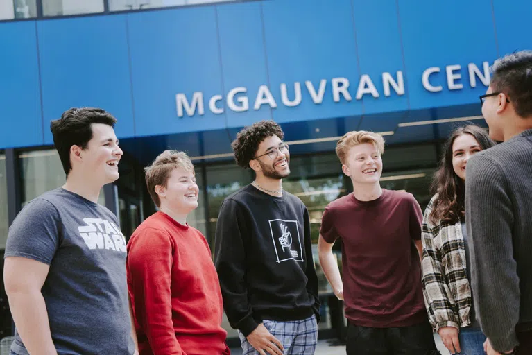 Male and female students outside McGauvran Center at UMass Lowell