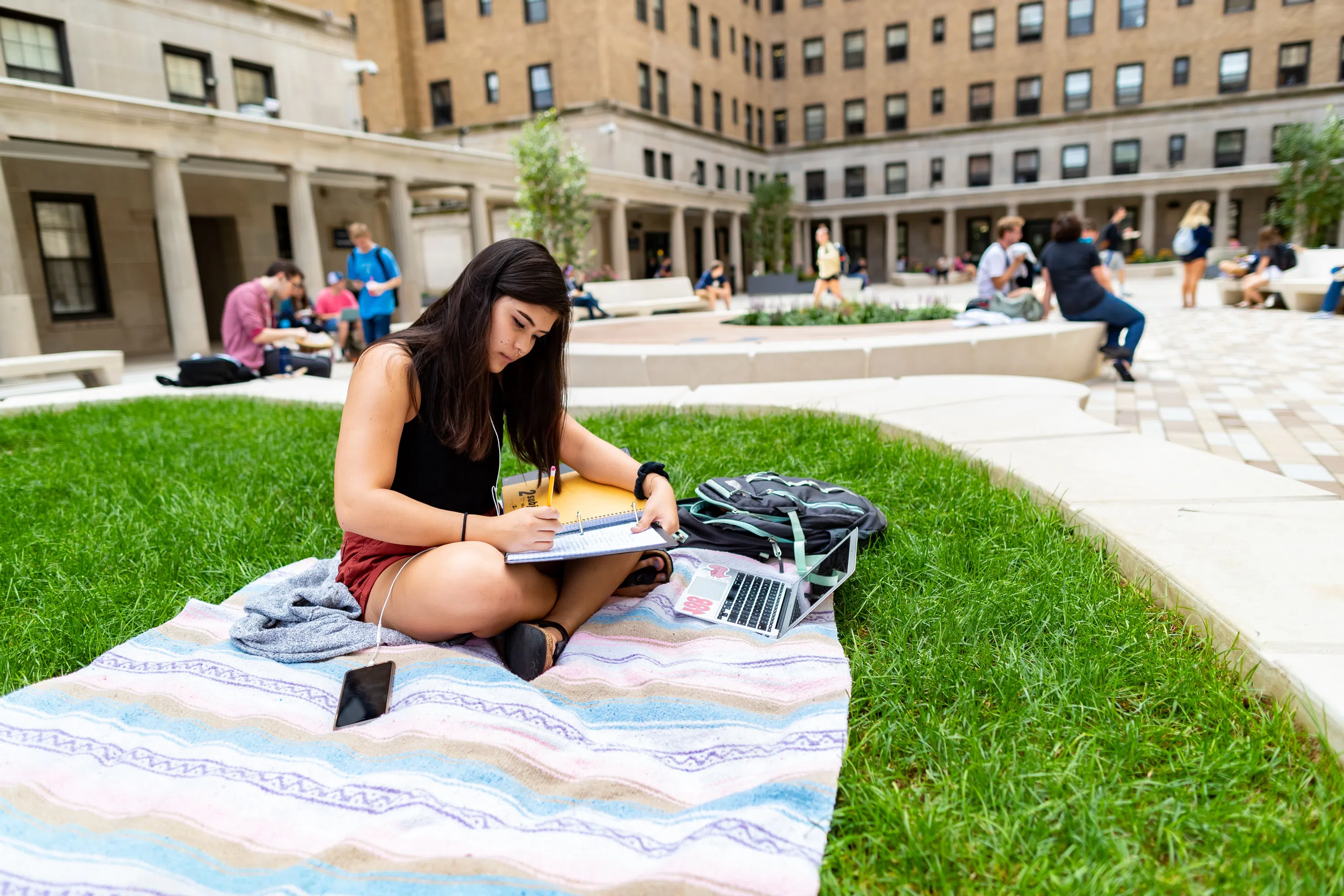 Student studying in Schenley Quad outdoor area