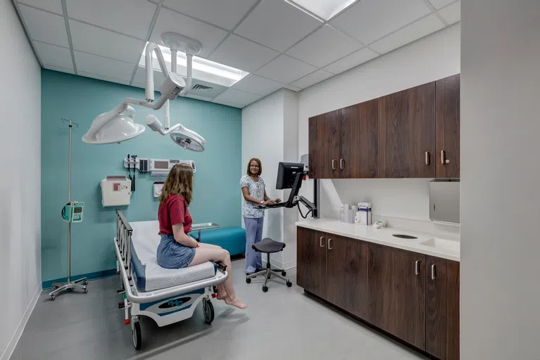 Student and physician in an exam room