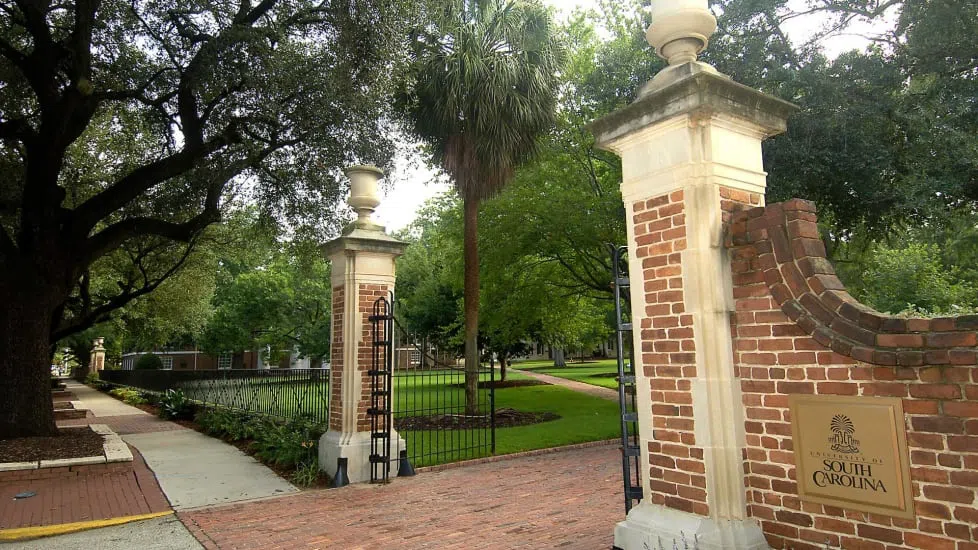 Iron gates open to the brick path of the Horseshoe