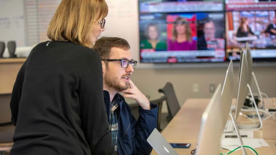 A professor and a student work on a senior semester project.