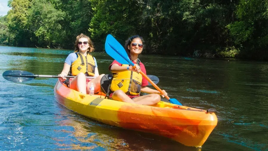 Two students canoe on the Congaree River, which runs through Columbia, on a sunny day.