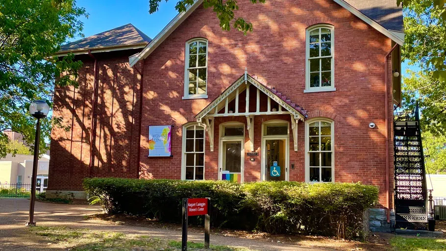 Exterior photo of the Margaret Cuninggim Women's Center, a two-story 19th Century red brick house.