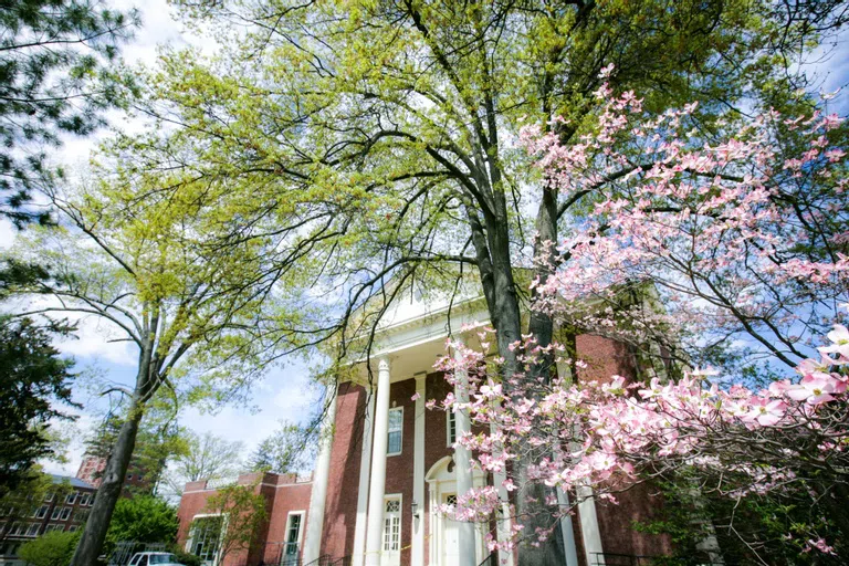 Exterior of Gordon Commons with trees and flowers