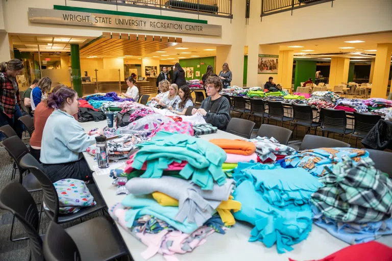 Students volunteer to make blankets to donate to Children's Hospital in the Student Union Atrium