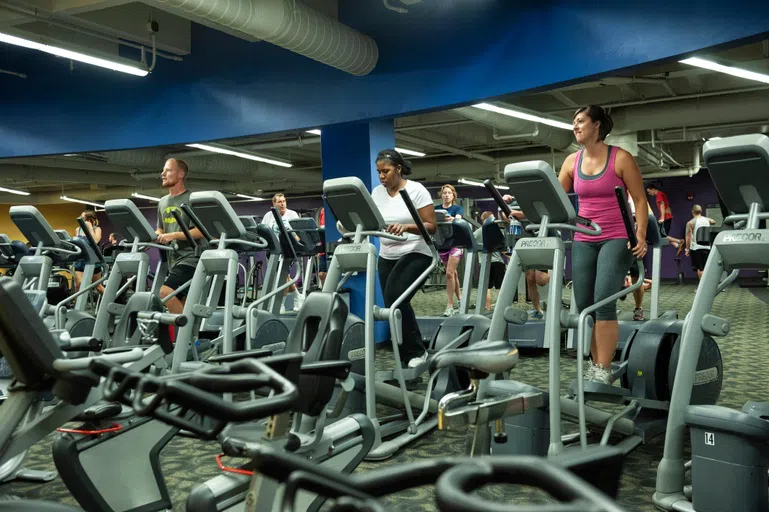 Students working out on elliptical machines.