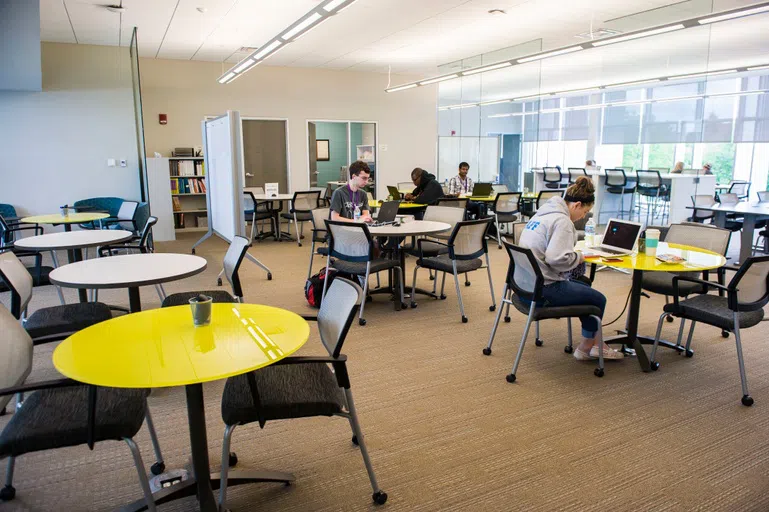 Students working individually in study spaces inside the Student Success Center.