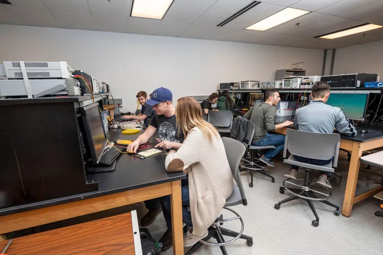 Students working in pairs on a project in a classroom.