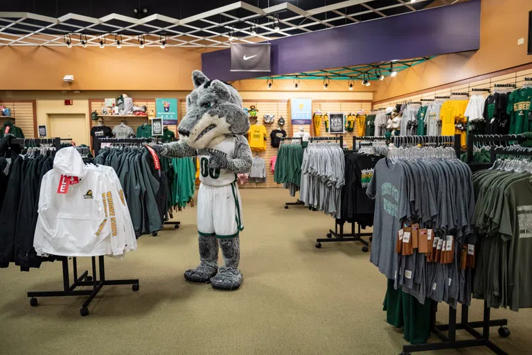 Rowdy looking through clothes in the campus bookstore.