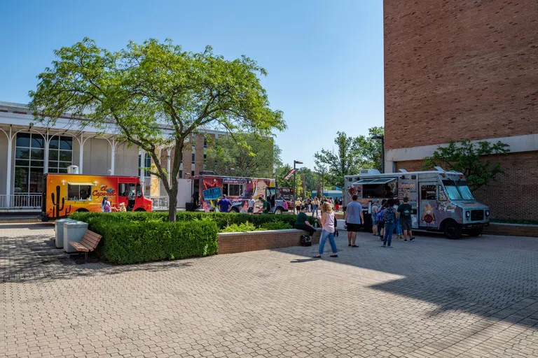 Food trucks parked on the quad during First Weekend on campus.