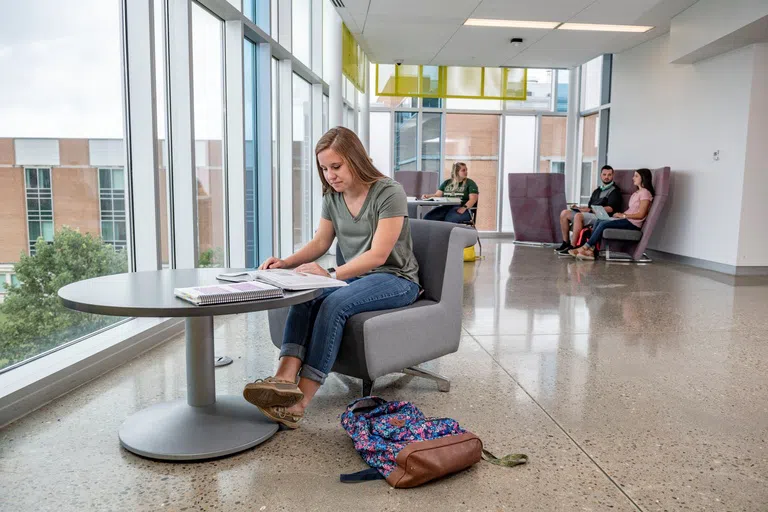 Students working at study spaces inside the Student Success Center.