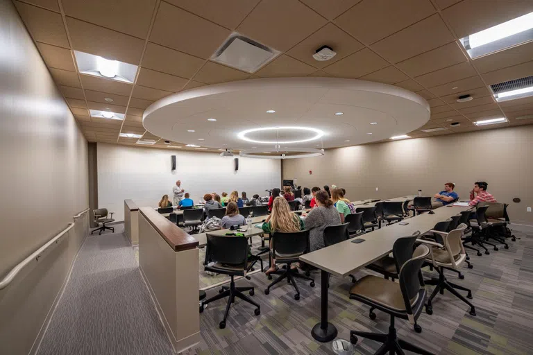 Students listening to a lecture in a classroom in Oelman Hall.