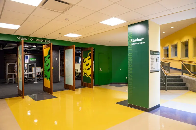 Student organizations have their own space in the Student Union to collaborate and have meetings. The photo shows their meeting space with a variety of spaces for them to sit and work.