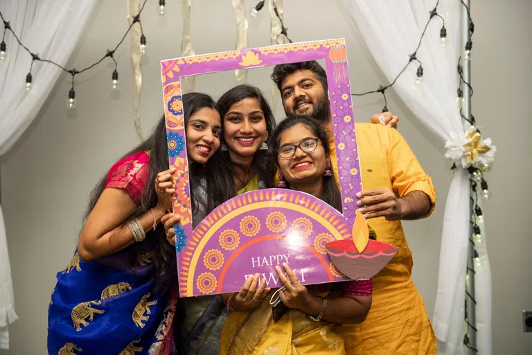 Students pose for a picture during the University Center for International Education's Diwali Celebration