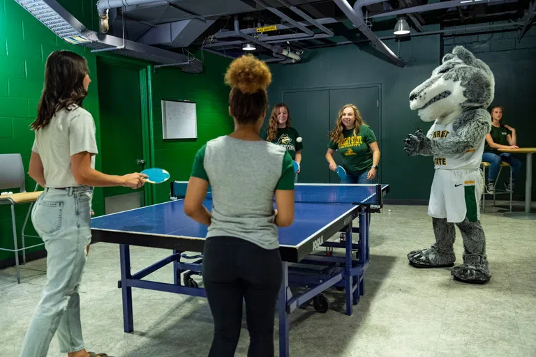 Students play on the ping pong table in the Student Union.