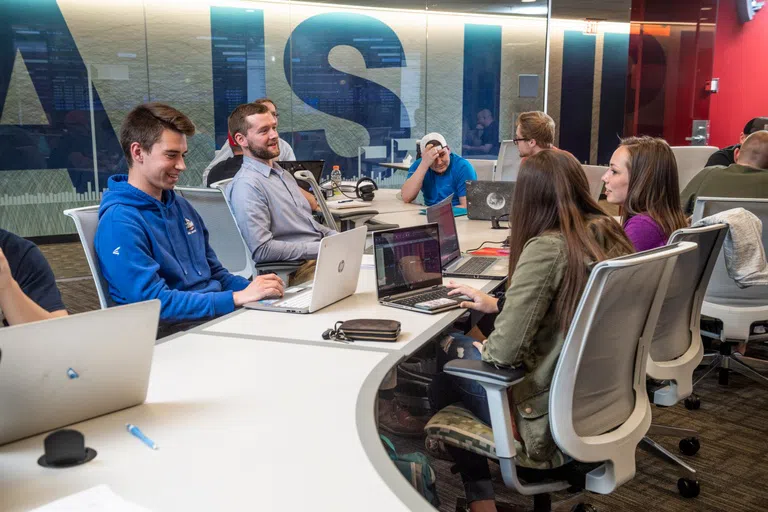 Students work in groups in the Data Analytics and Visualization Environment Lab.