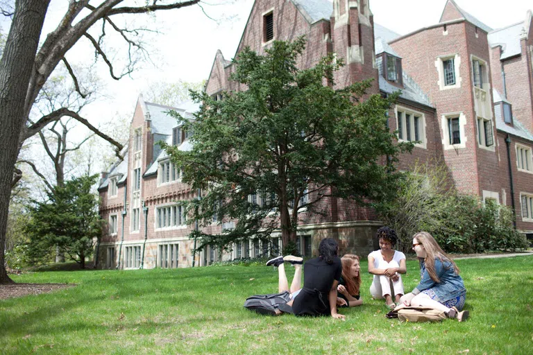 Students in the grass on Stone-Davis quad