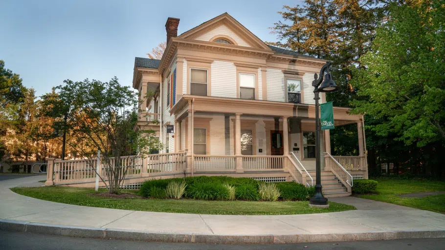 white two story house with steps and porch