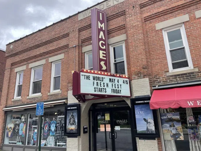 front of theater with sign advertising films