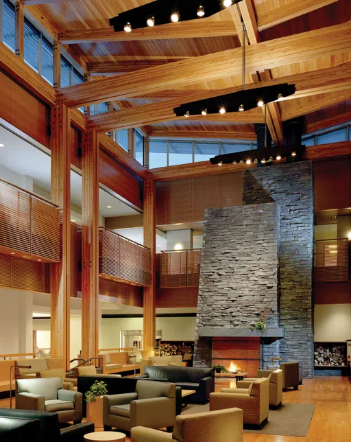 Wooden living room space with stone fireplace