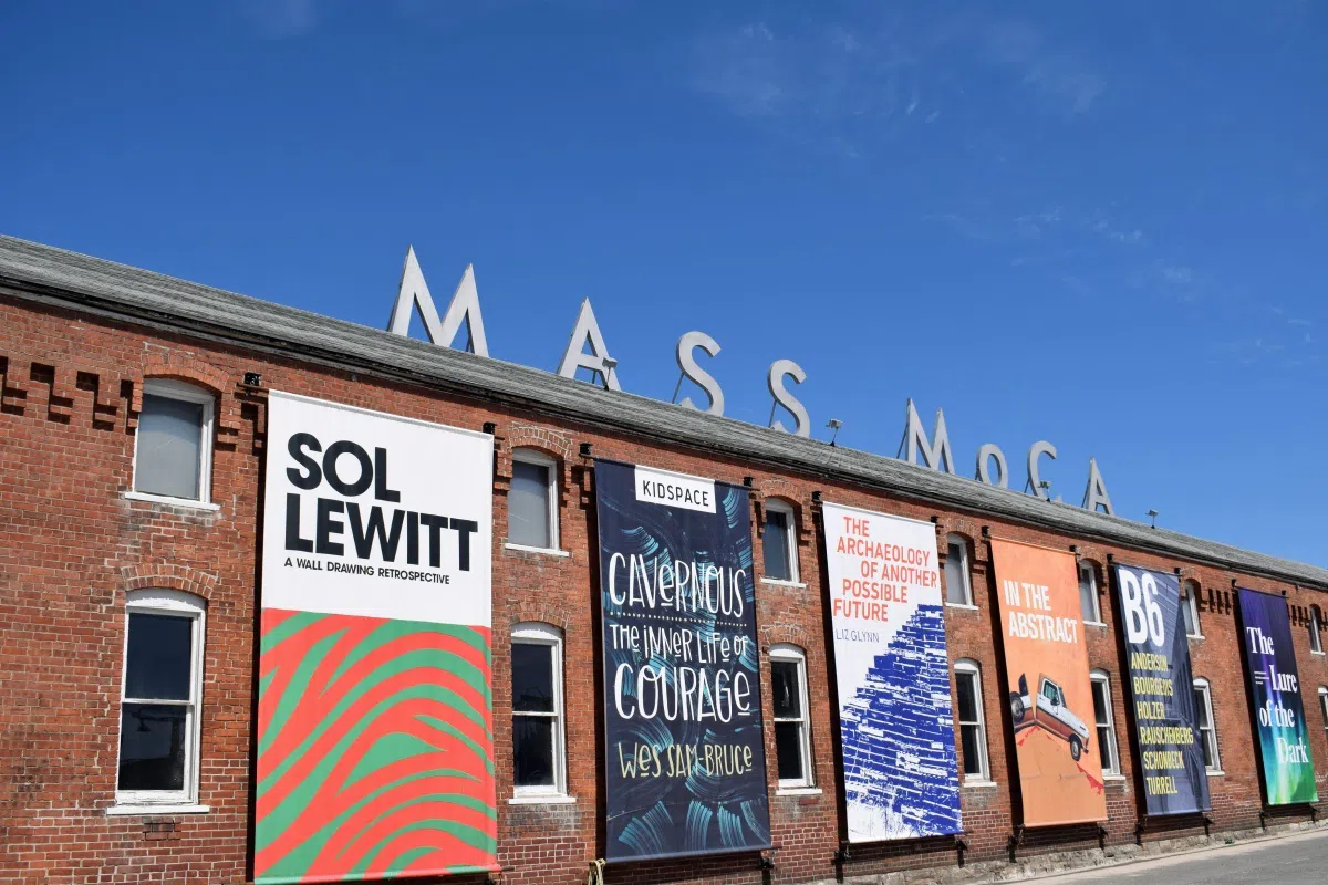 front of MASS MoCA with posters of current exhibit