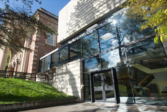 front of concrete building with glass windows and entrance