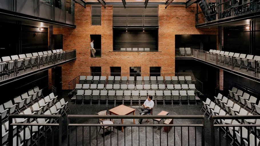 the CenterStage with round seating and a small set of a desk and chairs, with wooden background