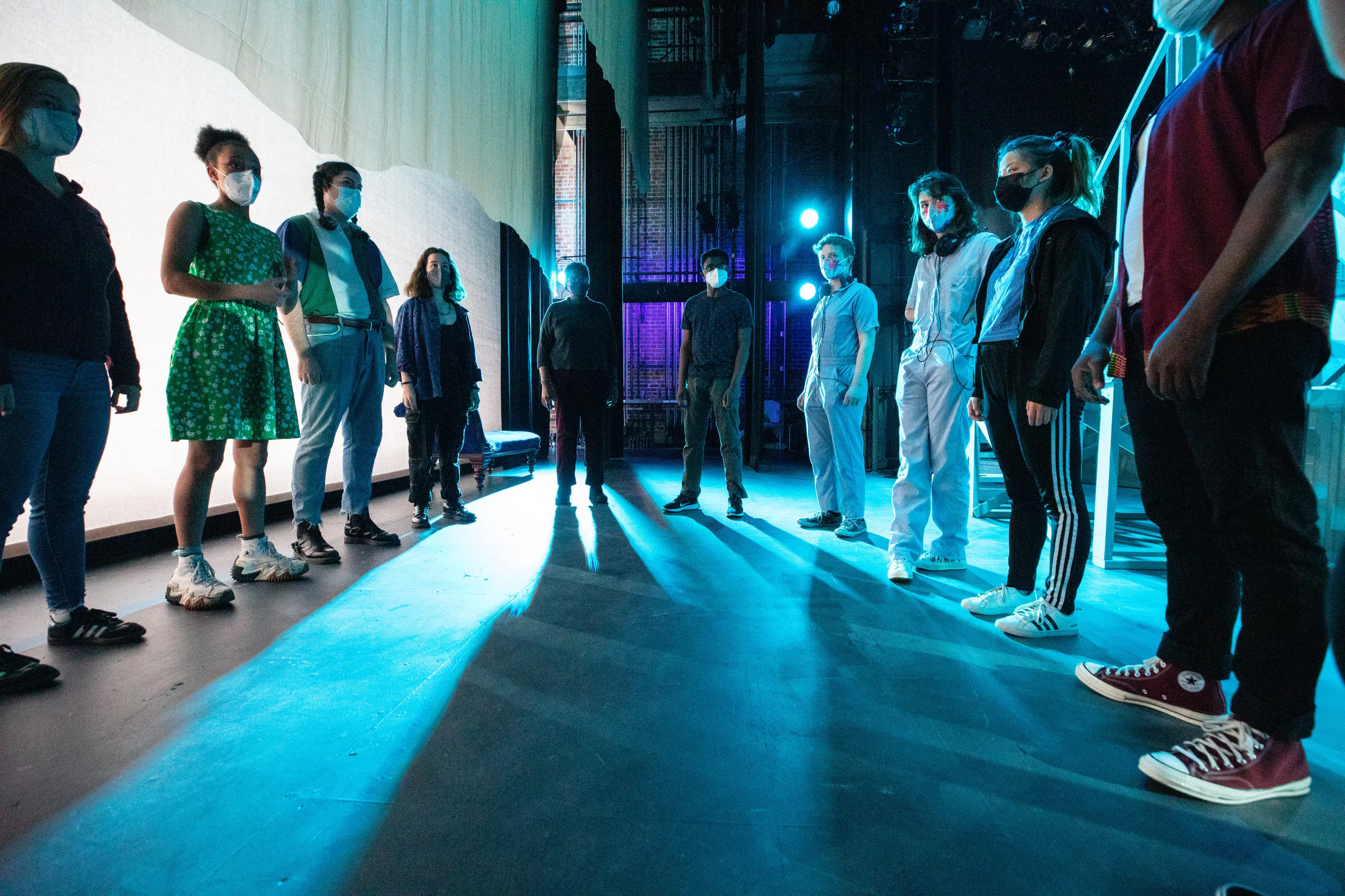 A group of performers gather backstage