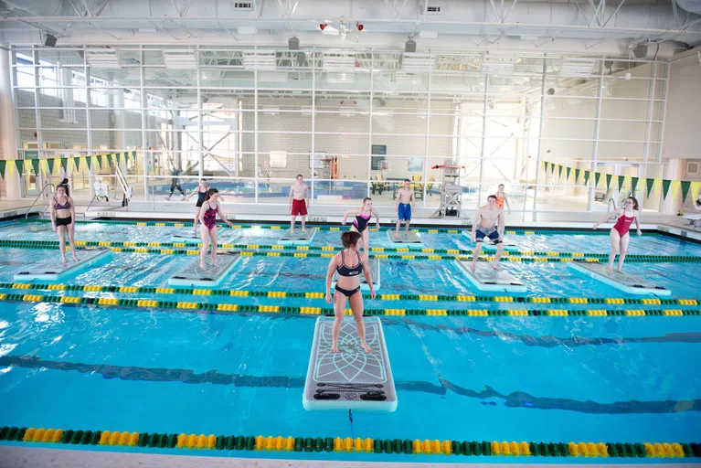 The Wellness Center offers intramural sports and GroupFIT classes specific to the aquatic center, like canoe battleship, paddleboard yoga, and more.