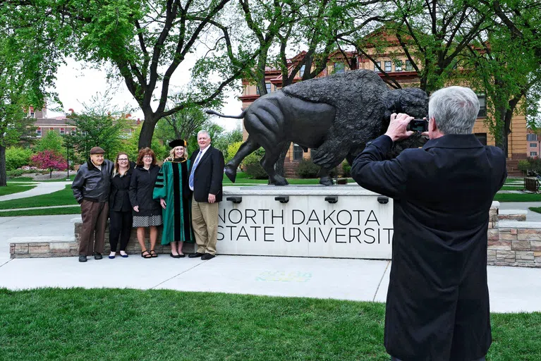 Commemorate your time at NDSU by taking a photo with family at the Bison Statue for graduation.